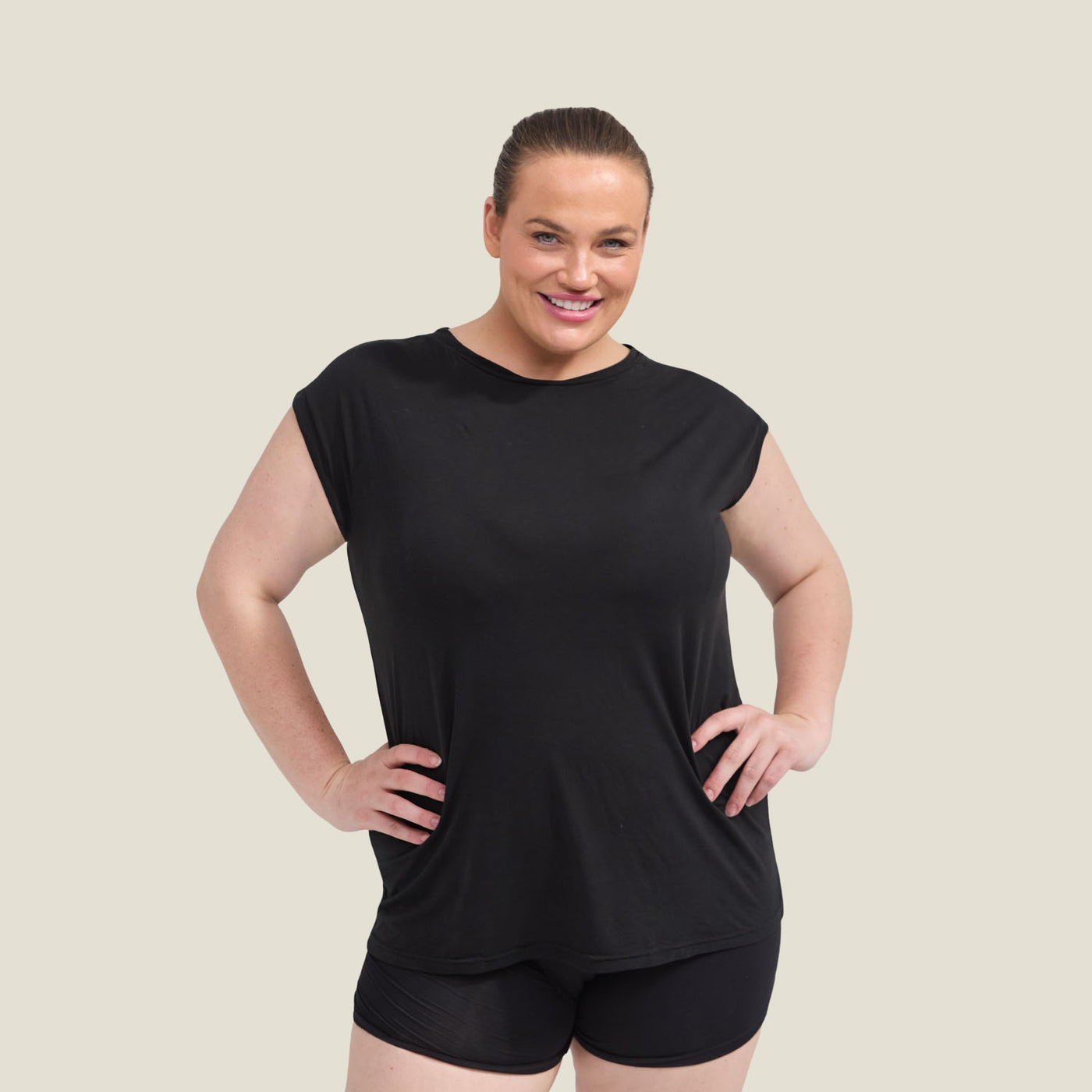 Front view of WUKA Menopause Pyjama Jersey T-Shirt in black, worn by plus size model, breathable and temperature-regulating sleepwear.