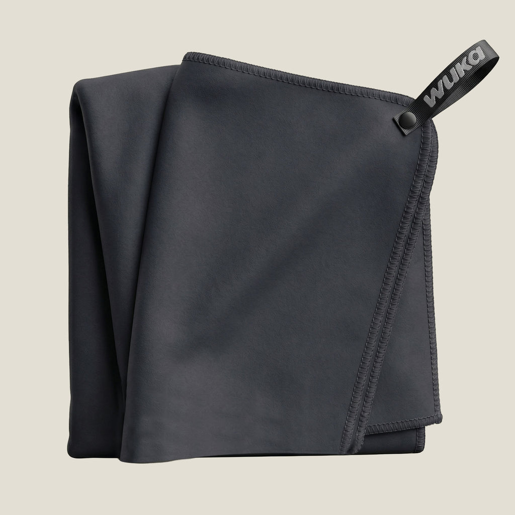 WUKA black quick-dry microfibre swim towel folded — compact chamois towel for swim kit bags