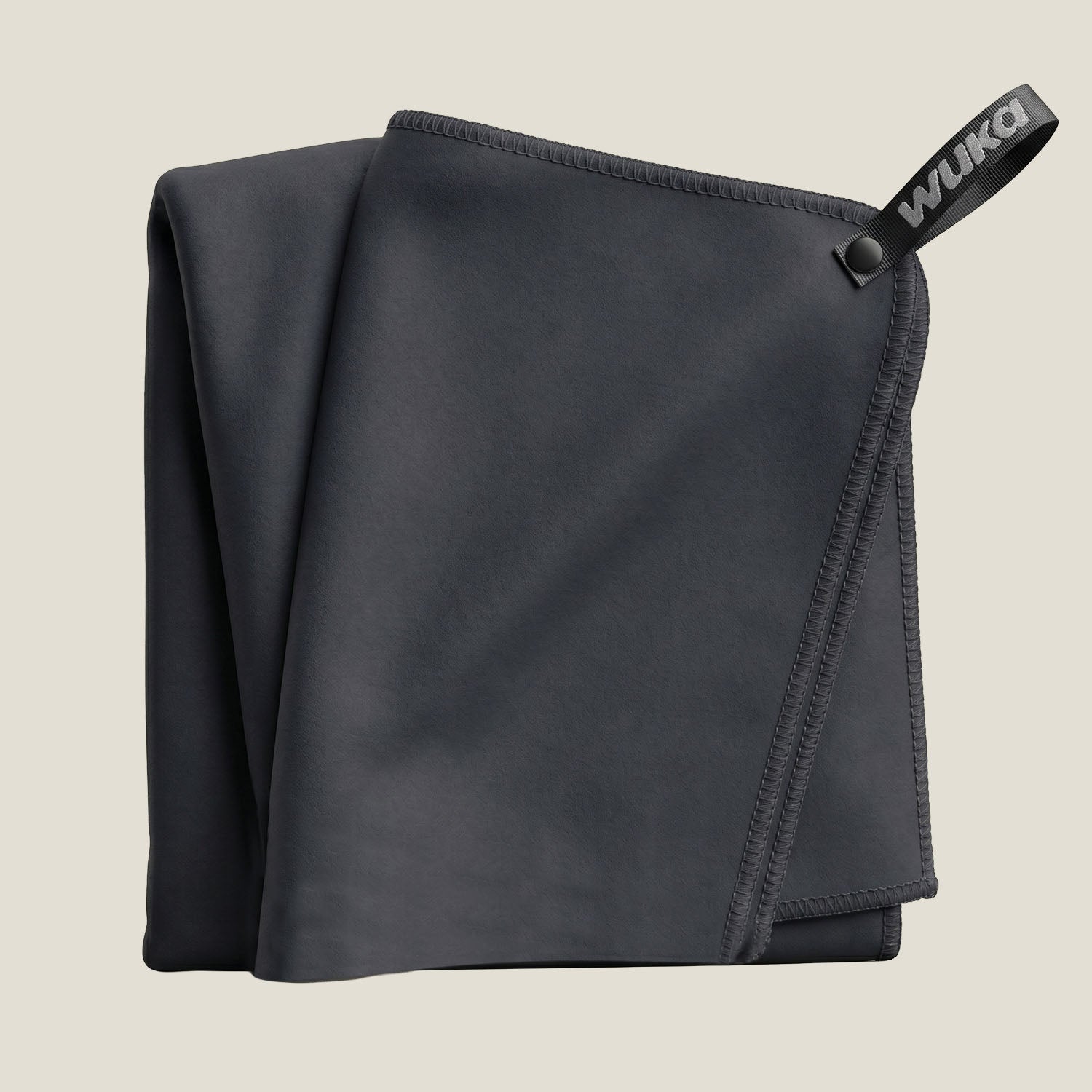 WUKA black quick-dry microfibre swim towel folded — compact chamois towel for swim kit bags