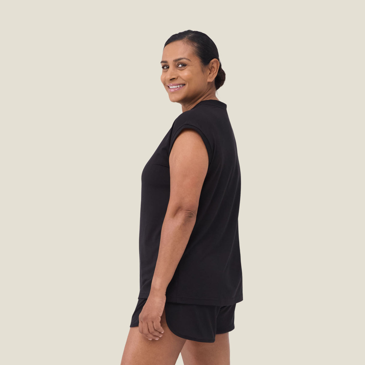Side view of woman wearing WUKA Menopause Pyjama Set – lightweight, anti-odour black jersey sleepwear for hormonal night sweats.