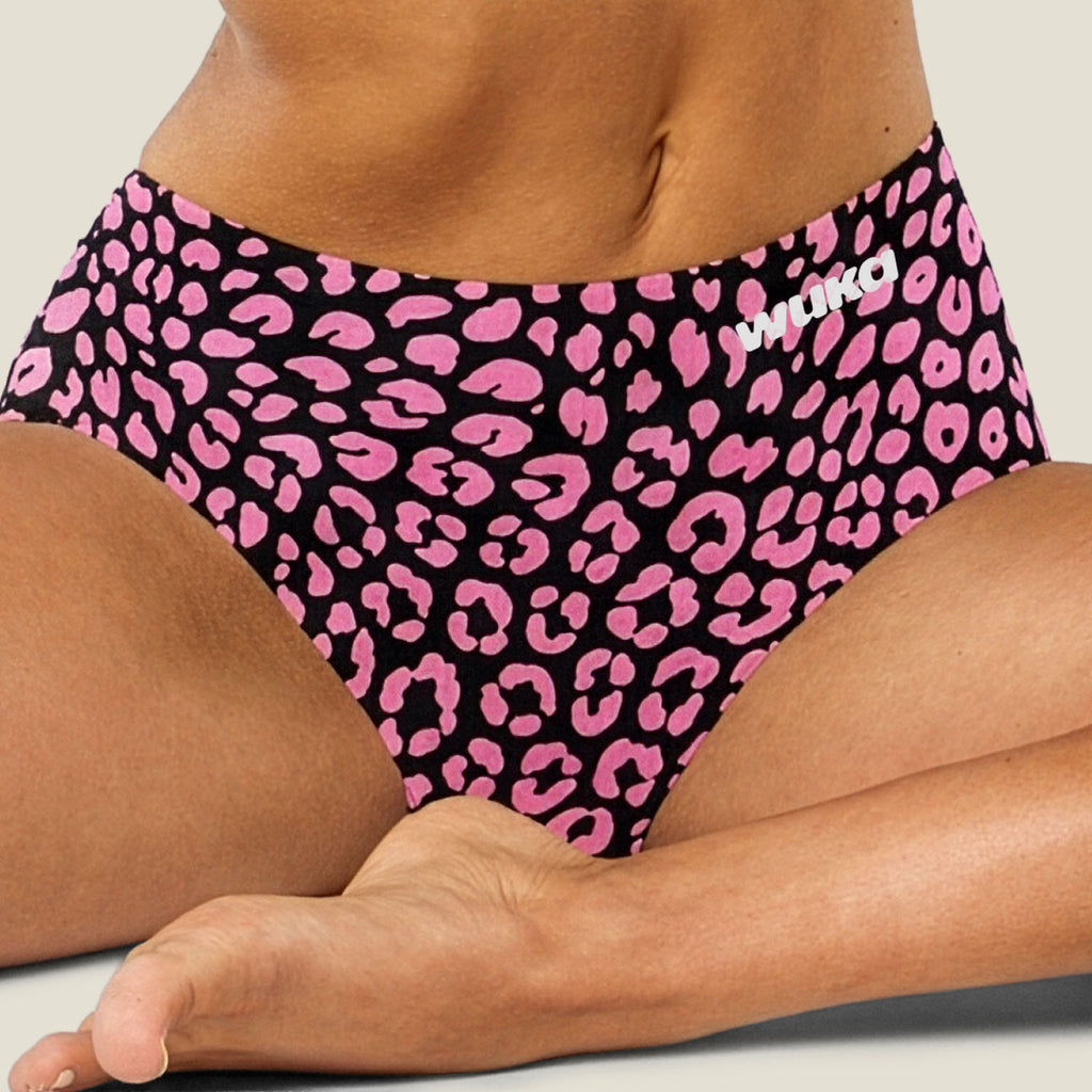 Close-up lifestyle image of limited edition WUKA Stretch™ Midi Brief in Pink Leopard Print for heavy flow. Stylish and sustainable period underwear offering 12-hour leak-proof protection, multi-size stretch fit, and bold design for confident, eco-friendly period care.